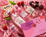 Pink gin gift hamper flat lay with gin, mixers and chocolates